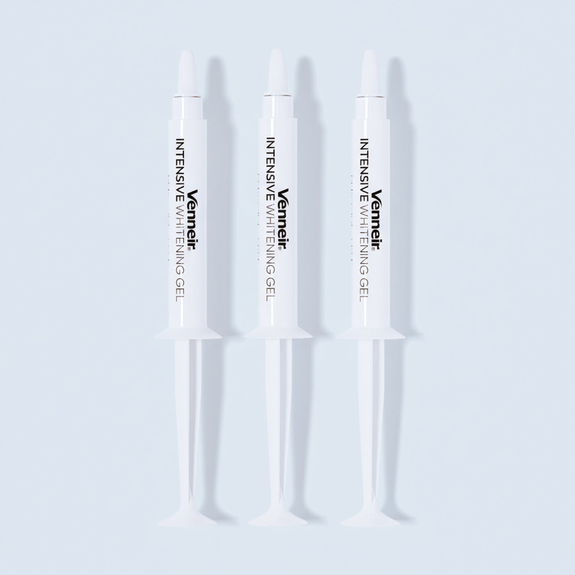 Three PAP whitening gel syringes for sensitive teeth on white background