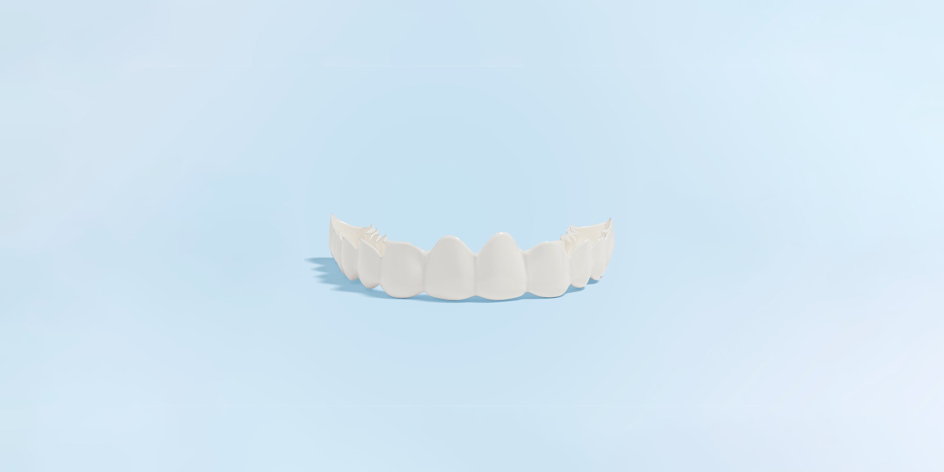 White snap-on smile on a light blue background