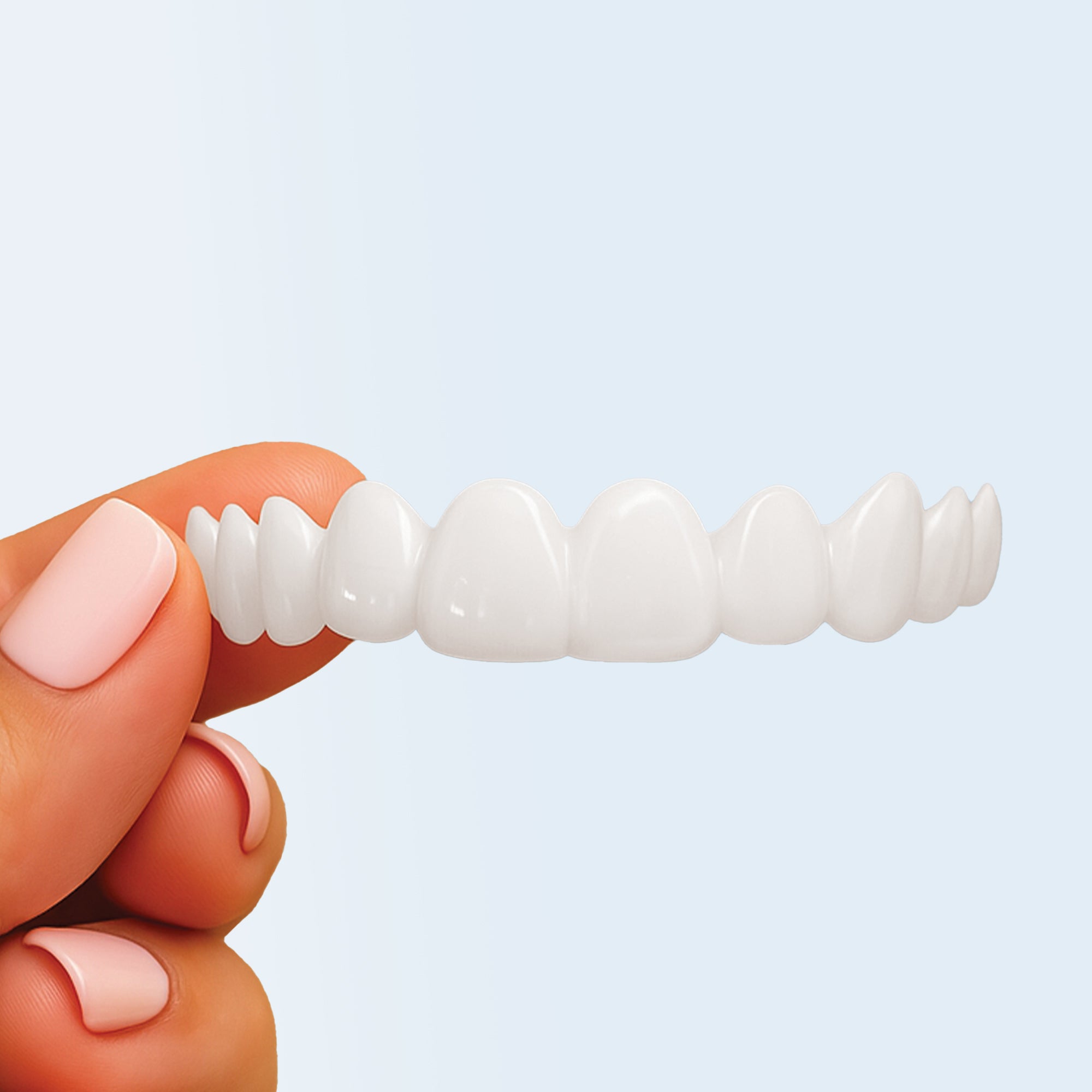 Woman holding natural white snap-on veneers for upper teeth