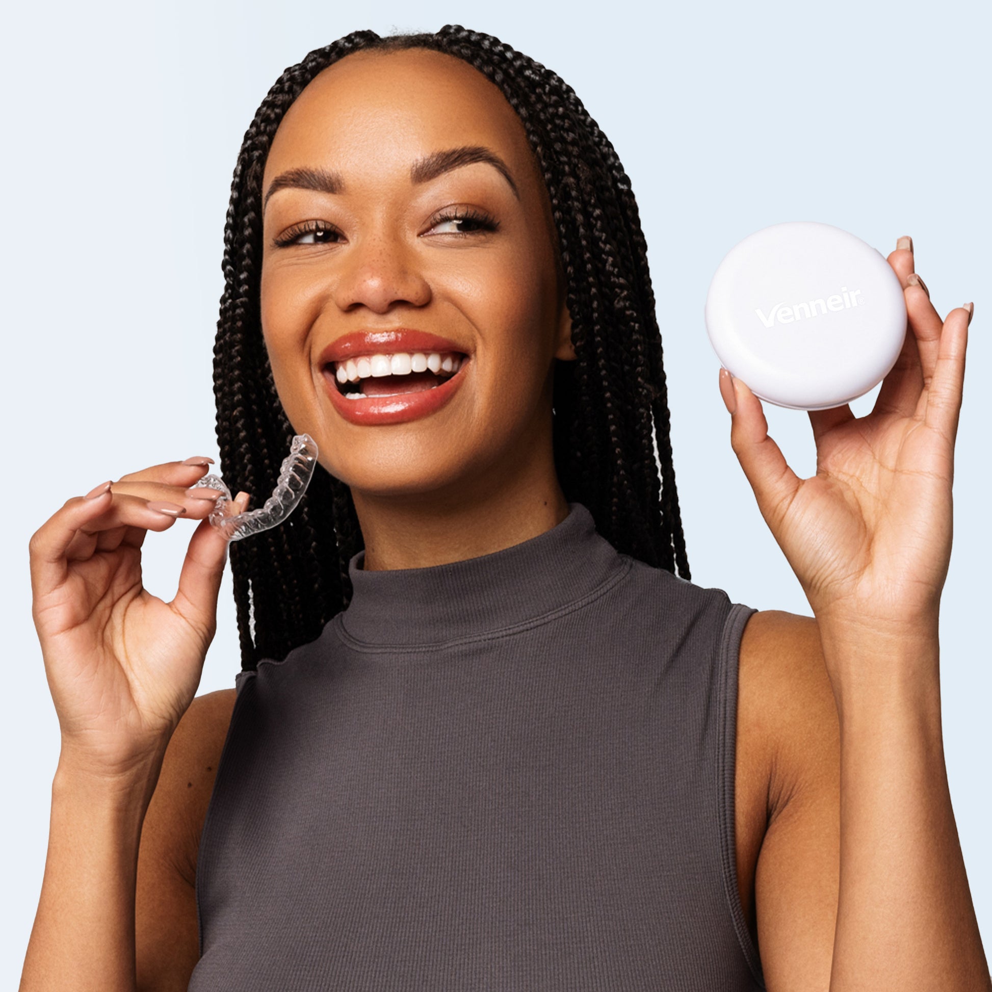 Woman holding clear upper retainer on blue background