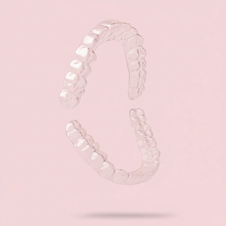 Clear upper and lower retainers on pink background