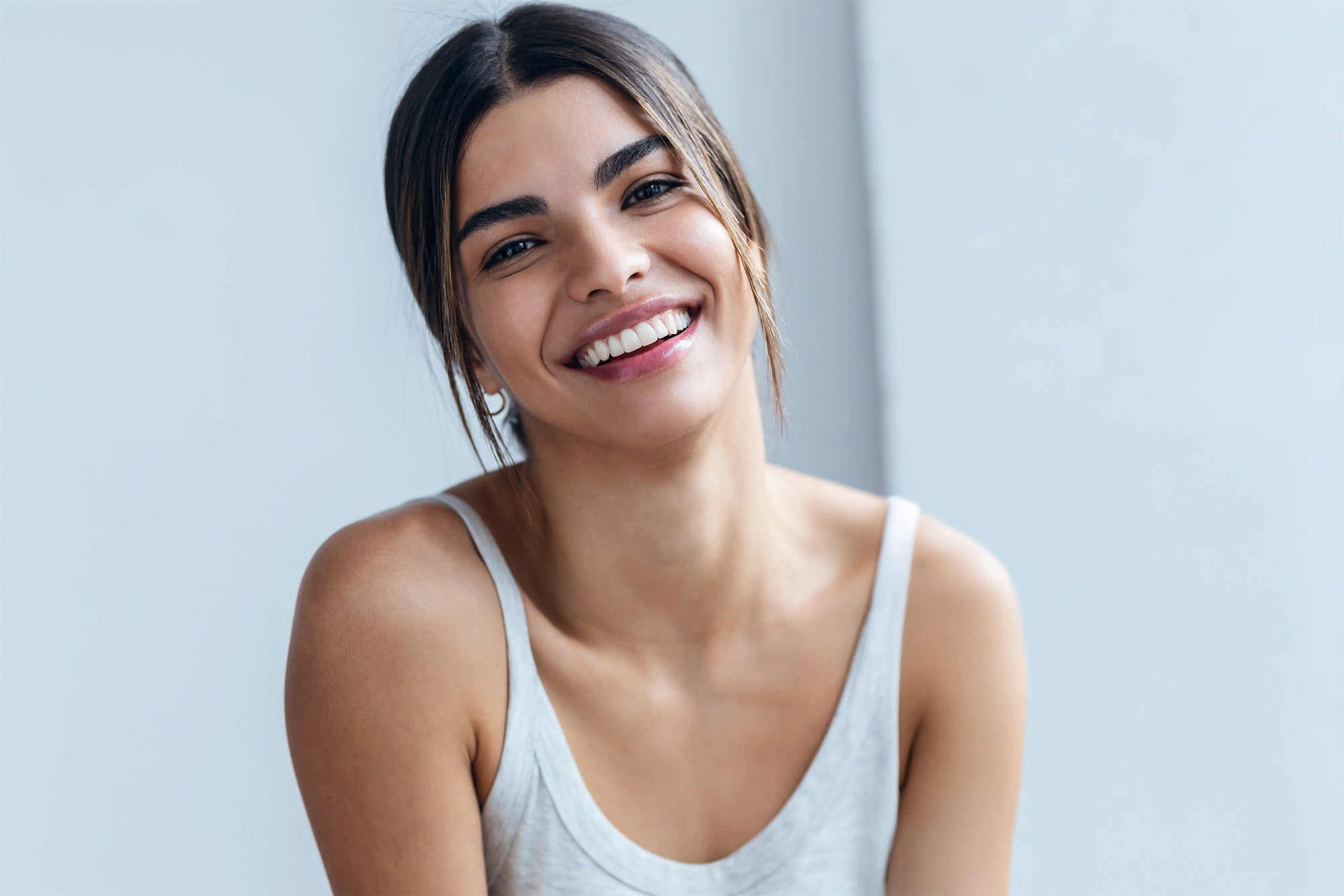 Woman smiling with a light gray background