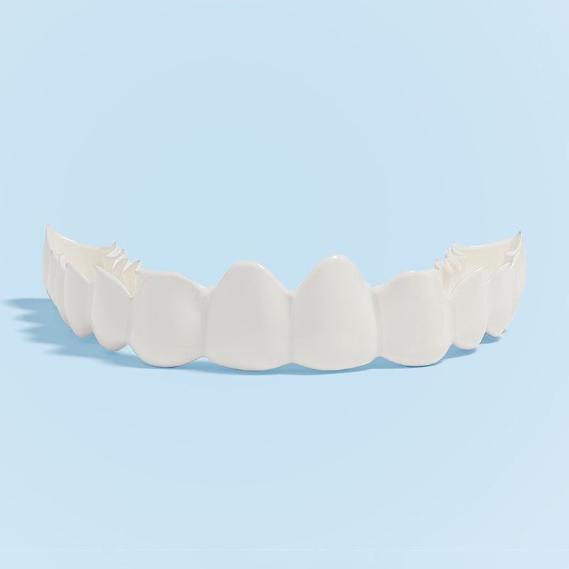 Set of white dental click-in veneers on a light blue background