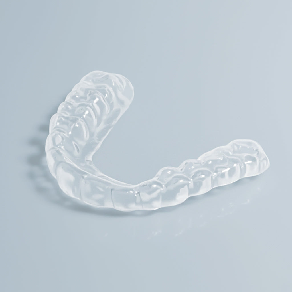 Clear slim night guard for teeth grinding and TMJ relief on white background