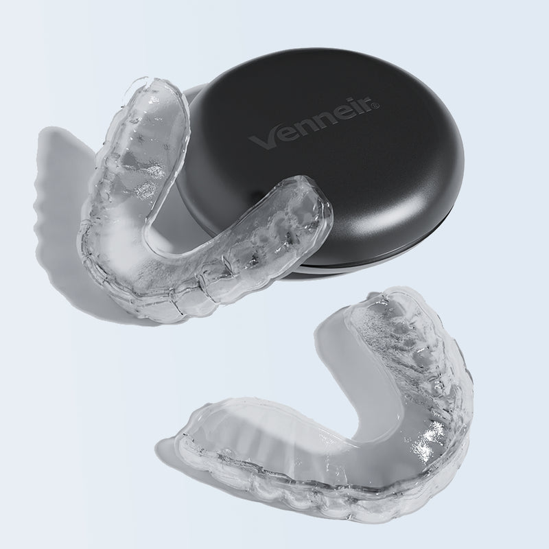 Clear mouthguard with black case on a light gray background