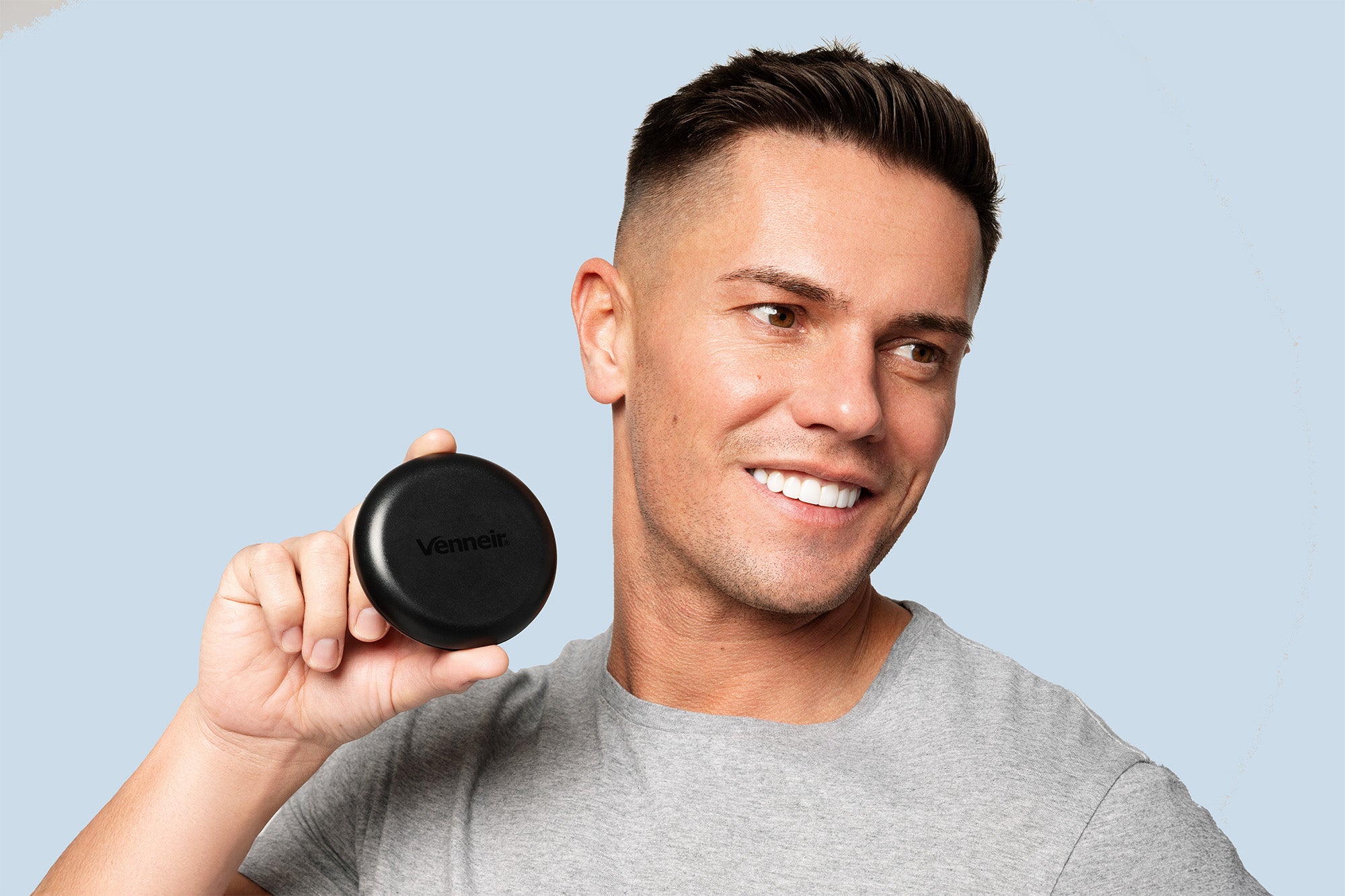 Man holding black retainer storage aligner travel case