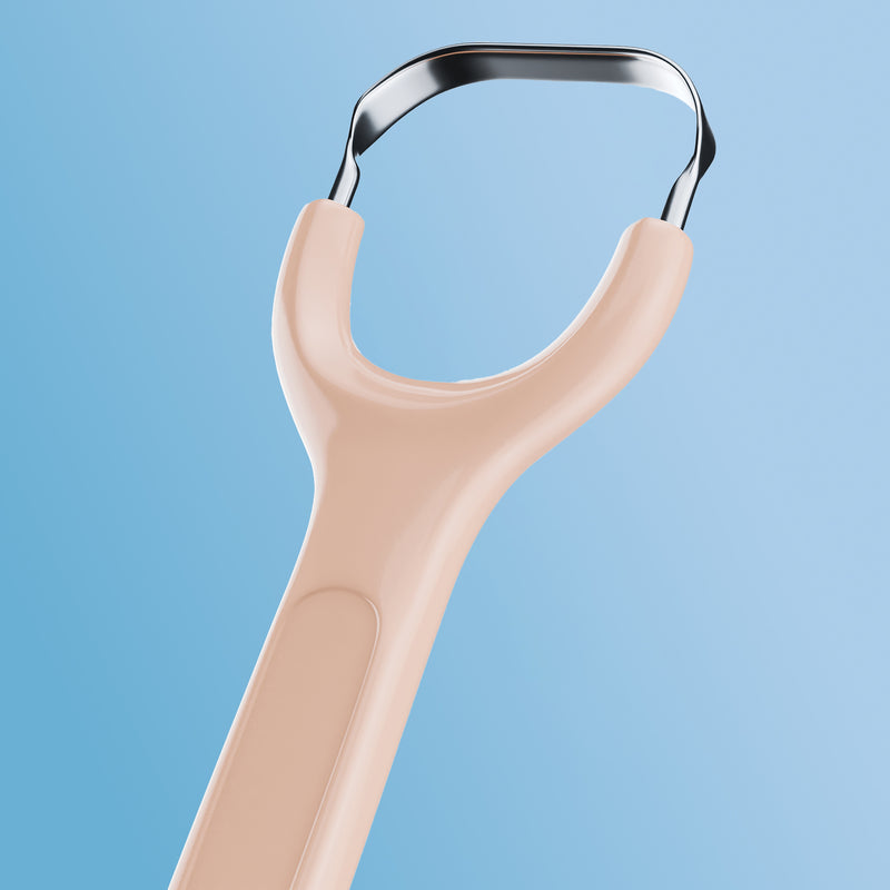 Orange Venneir tongue scraper on a light blue background