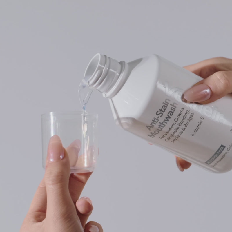 woman pouring mouthwash branded 'Venneir' into a clear cup