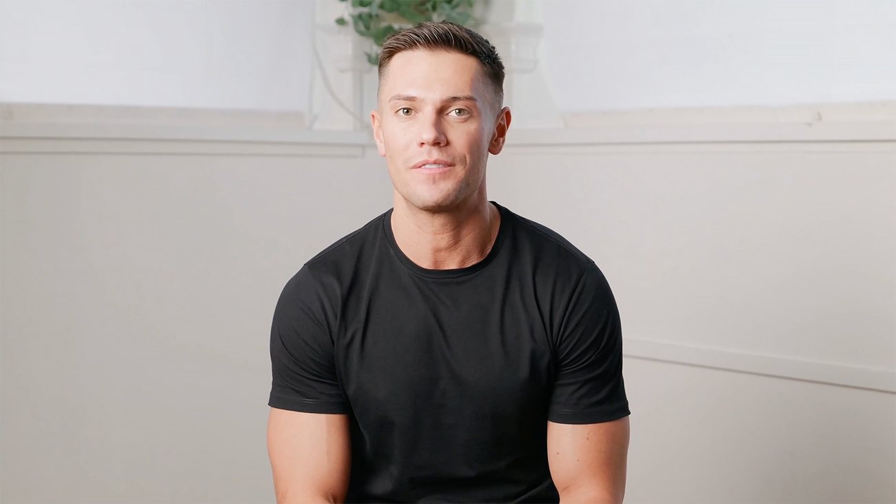 Man talking to camera about whitening trays in black t-shirt