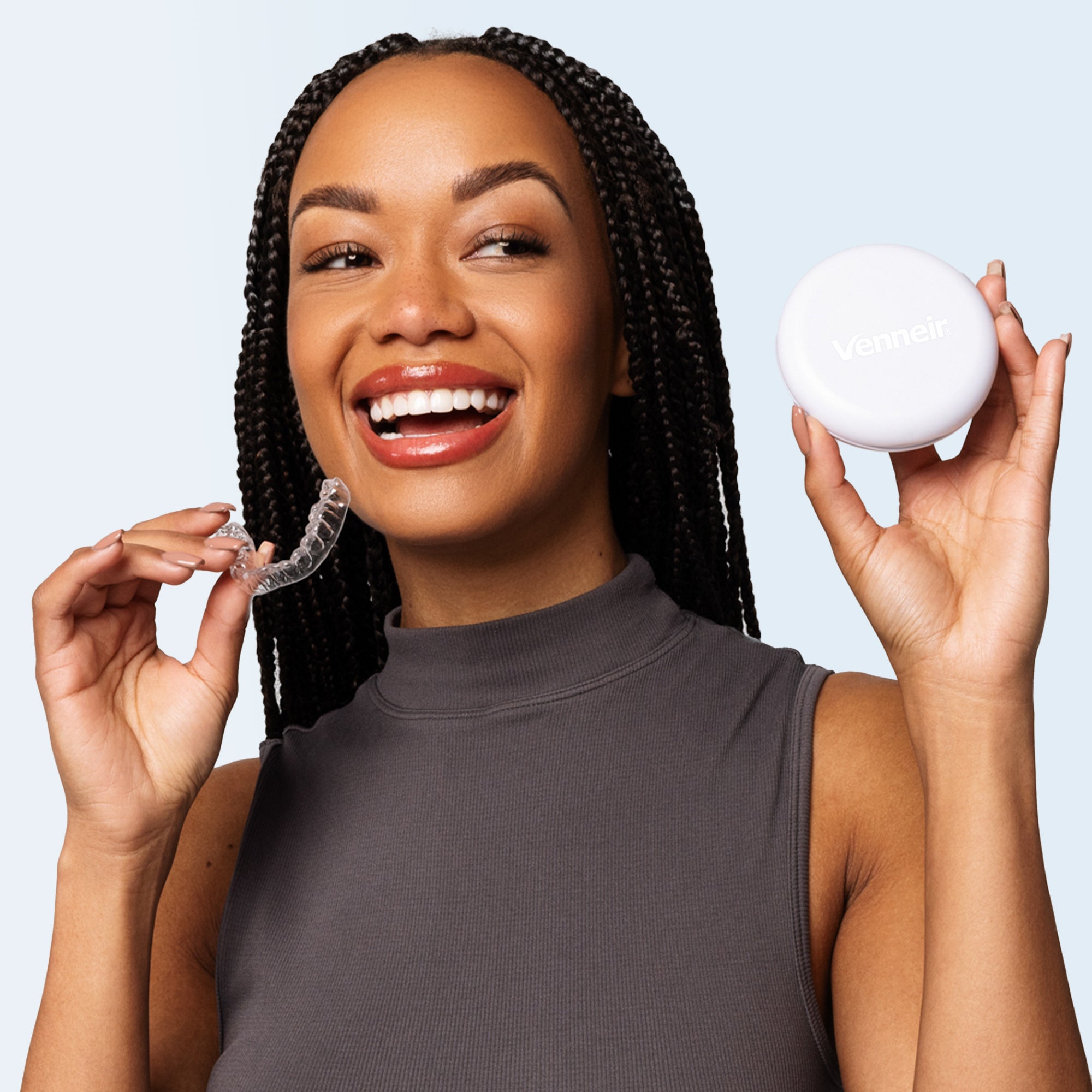 Woman holding clear upper retainer on blue background