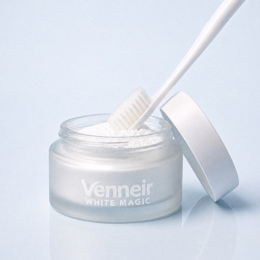 Jar of 'Venneir White Magic' toothpaste powder with a applicator on a light blue background