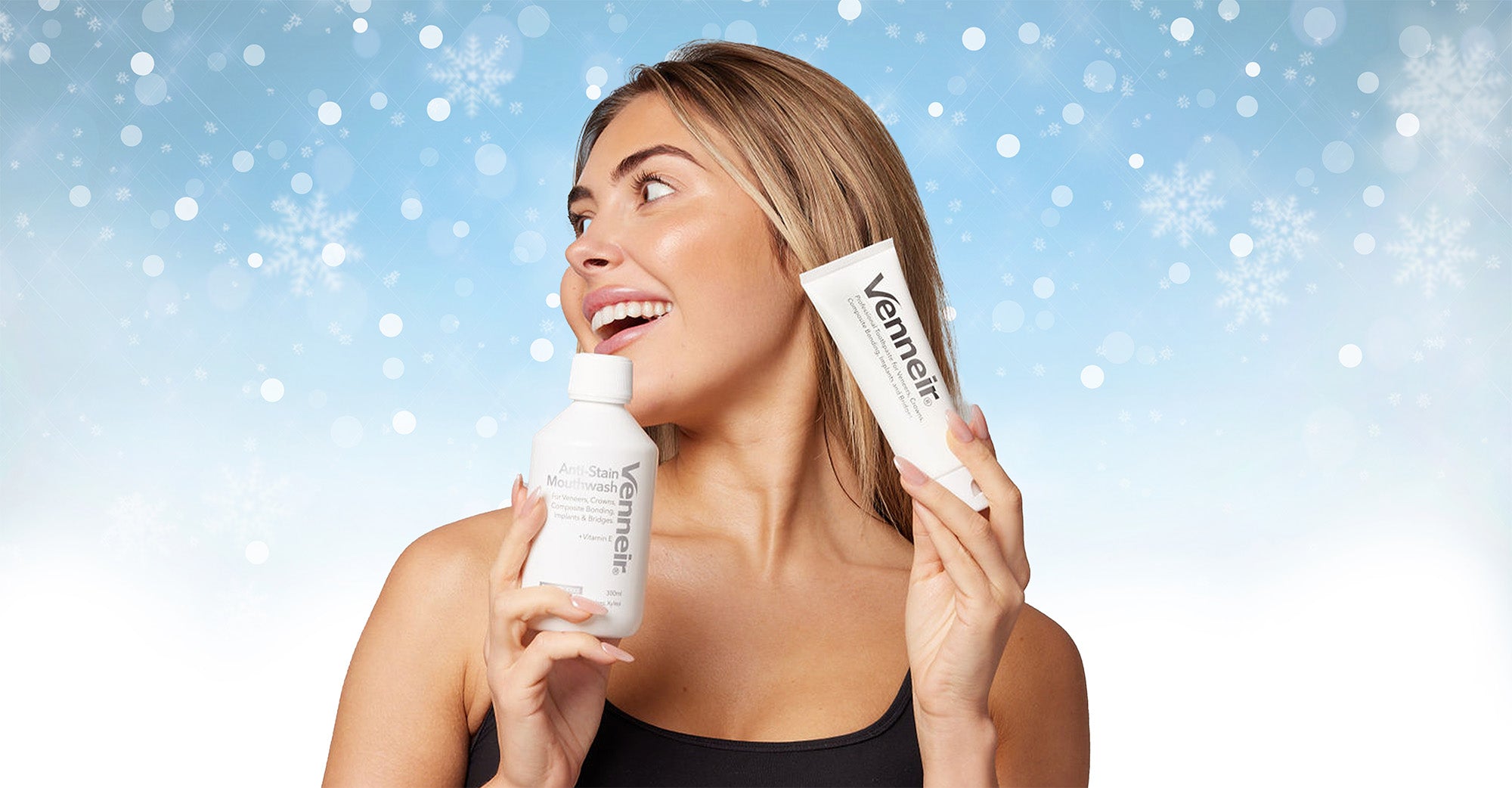 Woman holding a bottle and a toothpaste tube with 'Vennier' branding against a snowy background